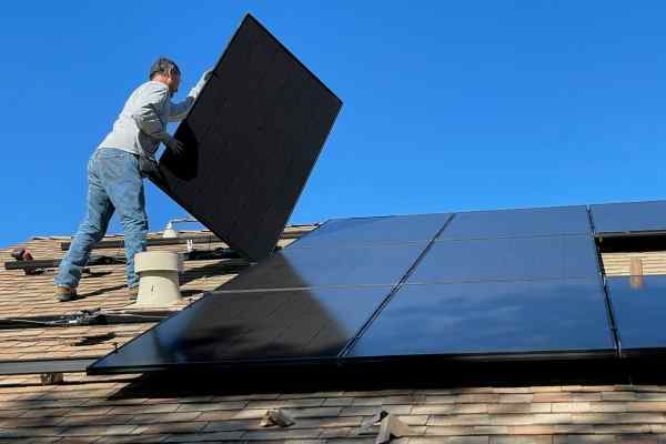Roofer Installing Solar Renewable Energy Panels